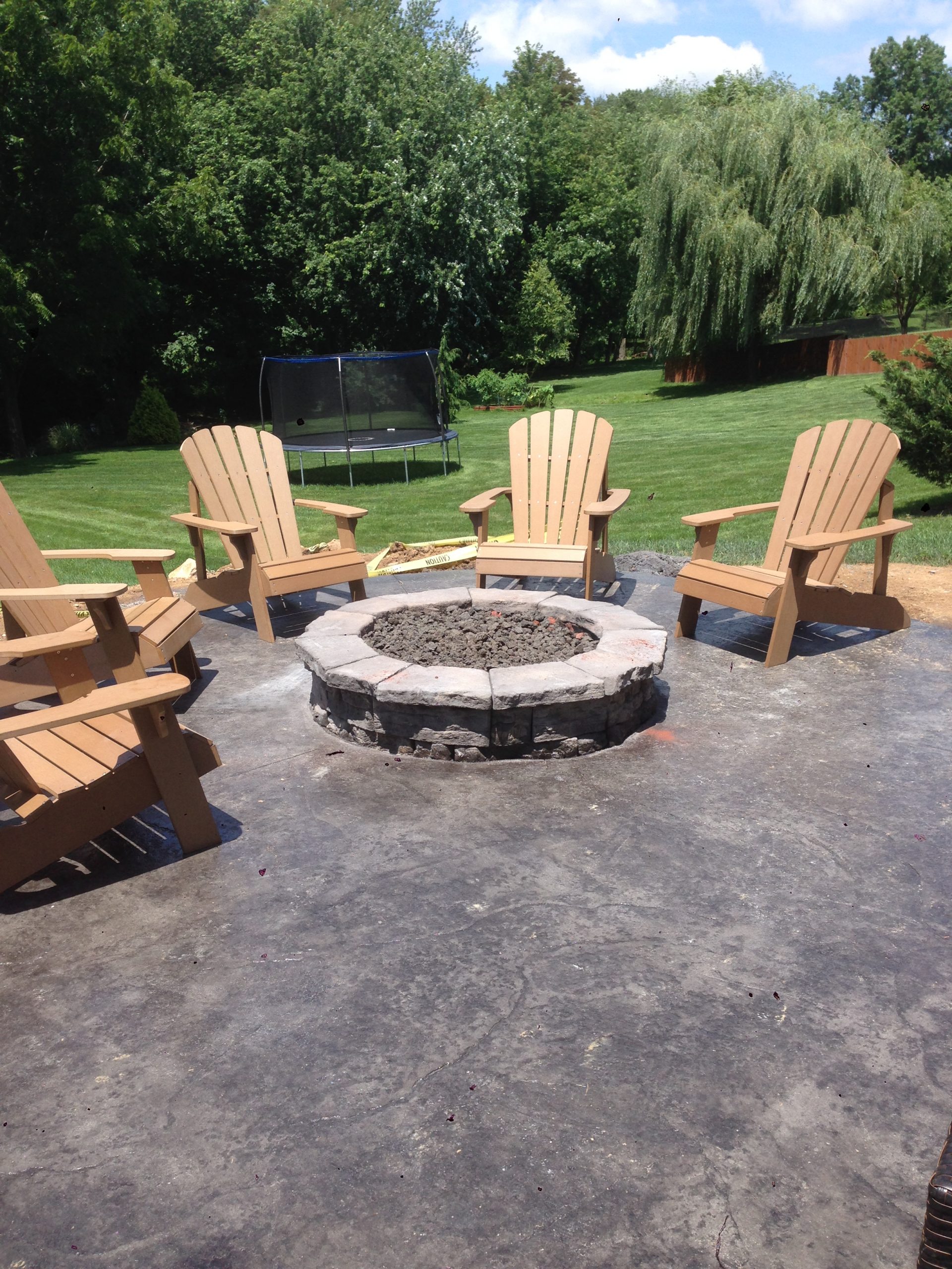 fire pit on patio with wood chairs